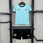 2025050114360345 | UAE SPORT STORE Light blue soccer jersey with black trim on display above black shorts on a metal rack promotes athletic wear.