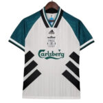 White Liverpool FC jersey on a hanger: white body, teal sleeves, black diagonal panels and Carlsberg sponsor.