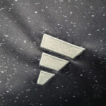 Three light-colored bars forming a Wi‑Fi signal strength icon on dark fabric.