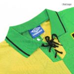 Close-up of a green and yellow Umbro polo shirt collar with black lace-up placket and brand tag visible
