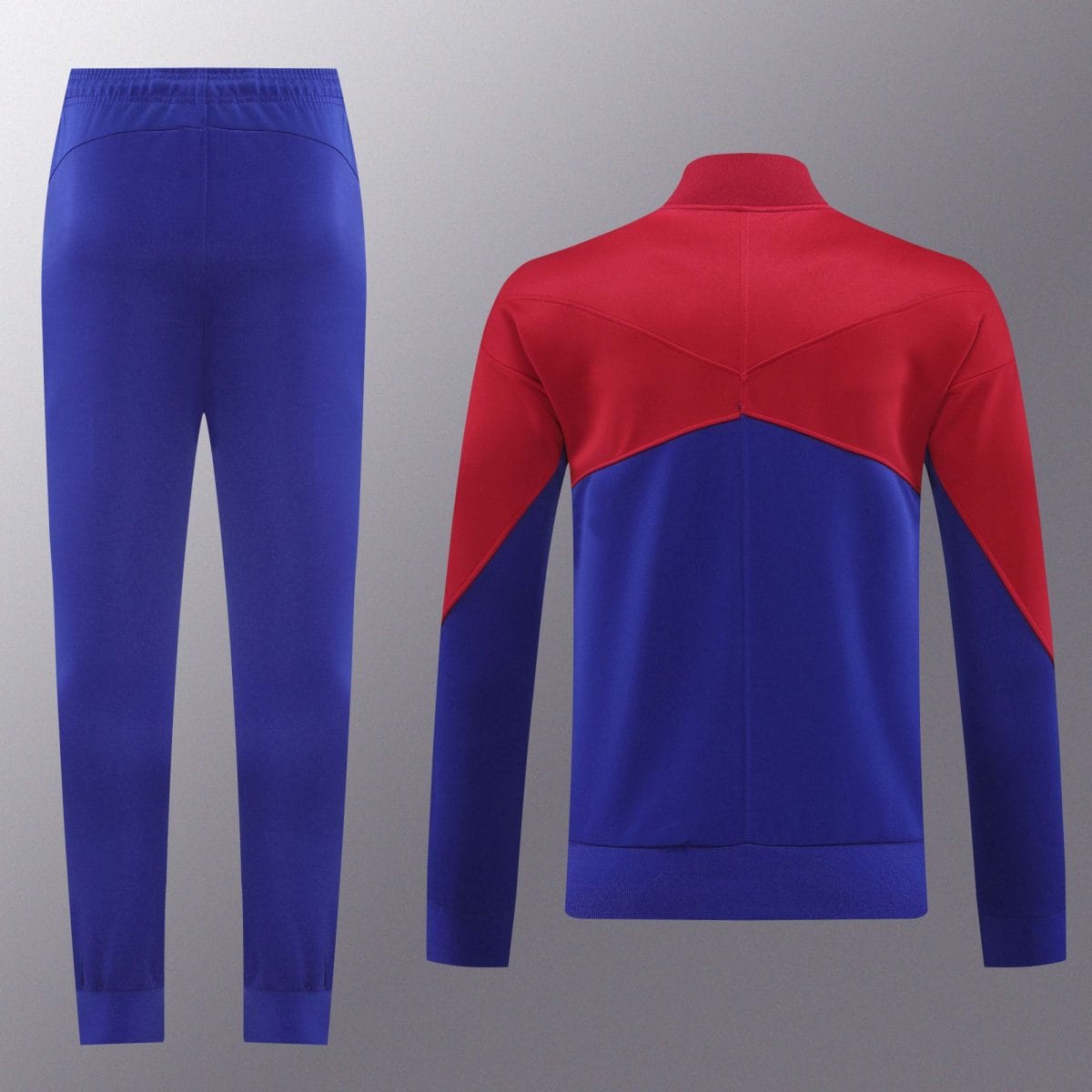Blue athletic pants shown beside a red-and-blue color-blocked jacket on a grey backdrop, fashion display image.