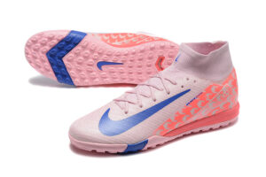 225aa688 | UAE SPORT STORE Pink Nike soccer cleats with a blue swoosh, showing the knit upper, laces, and patterned side panels.