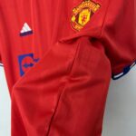 2266a94e_c41f506c-e674-46b6-9f36-61bed8bfaac3 | UAE SPORT STORE Red Manchester United jacket with club crest visible on the chest, along with an Adidas logo nearby.