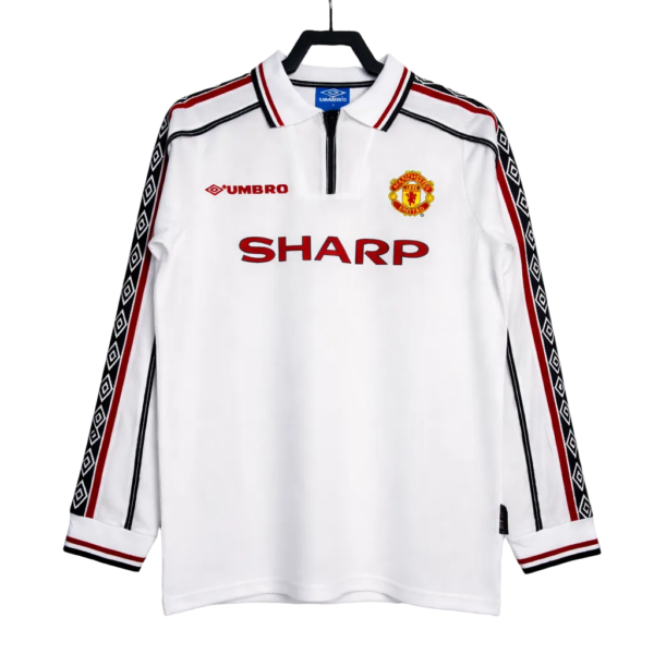 White Manchester United long-sleeve jersey with red SHARP sponsor, Umbro logo, and club crest on the chest.