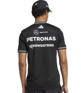 Person wearing a black Mercedes-AMG Petronas racing jersey seen from the back, with Petronas and CrowdStrike logos visible on the shirt and a cap on their head