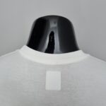 Close-up of a glossy black curved object emerging from white fabric.