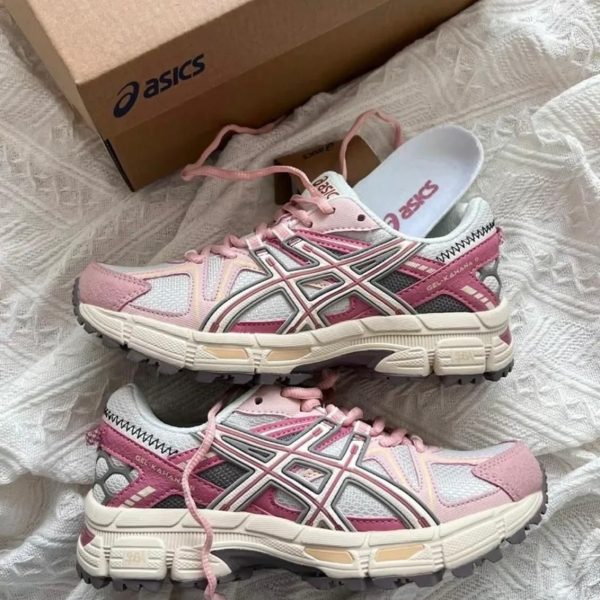 23672c0f-e3b5-4fc6-864c-8000362a555d | UAE SPORT STORE Pair of pink and white ASICS Gel-Kayano sneakers with matching laces on a white patterned surface, box in the background.