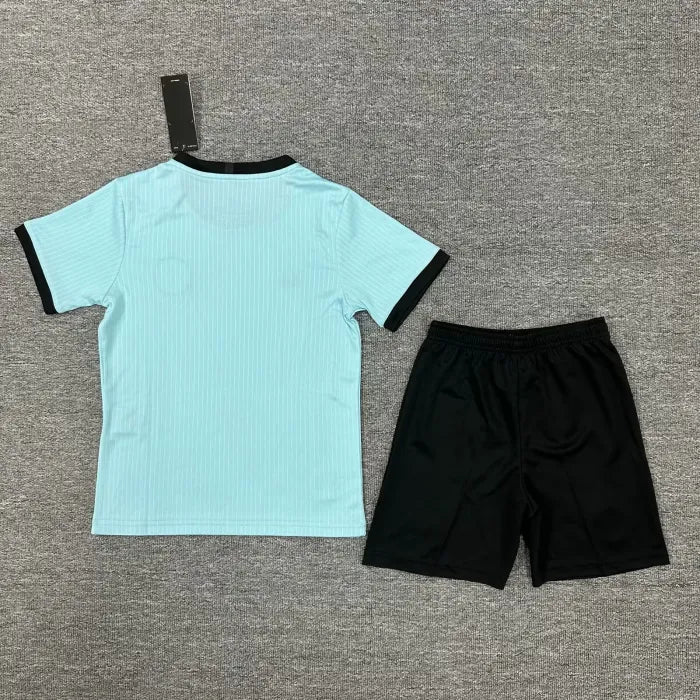 23a44860351c2c90 | UAE SPORT STORE Light blue short-sleeve shirt with black cuffs paired with black athletic shorts on a gray background, a kid's sports outfit set.