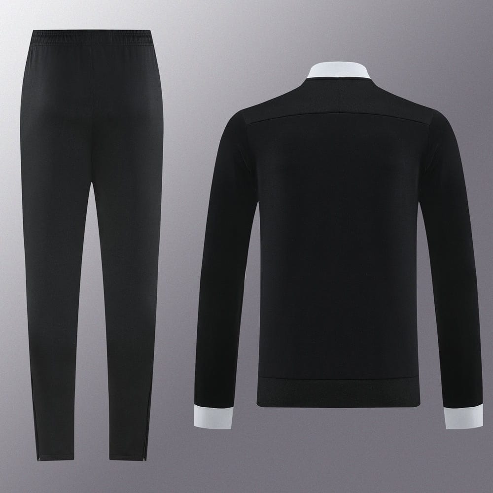 247b1752 | UAE SPORT STORE Rear view of a black suit jacket with white cuffs and matching black trousers on a gray backdrop