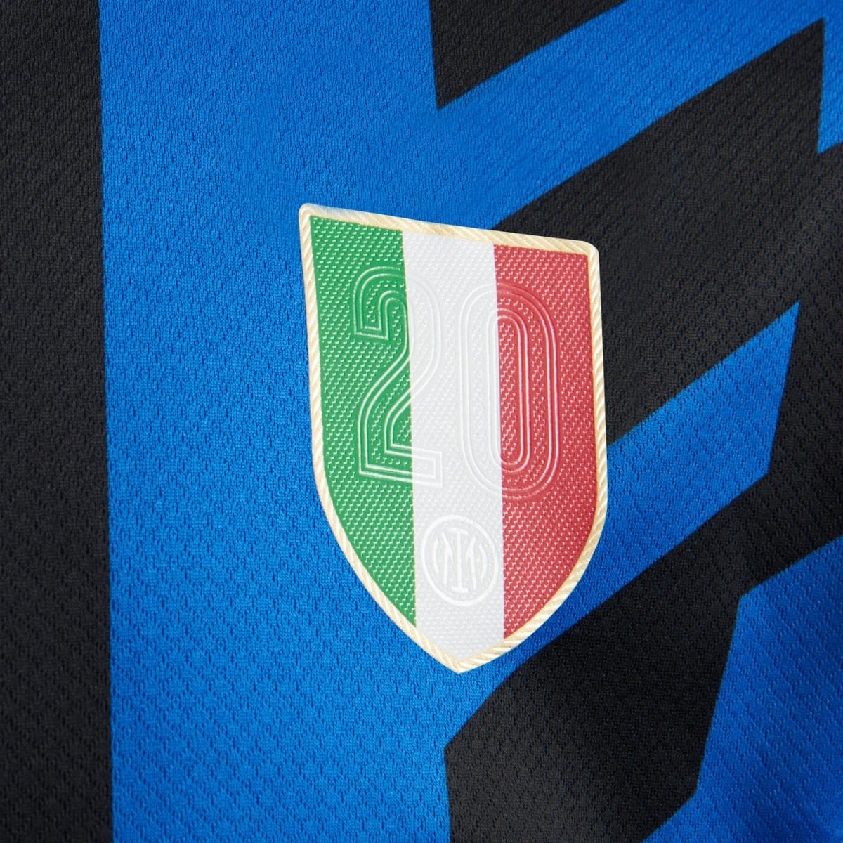 Close-up of a soccer jersey badge featuring the Italian flag colors (green, white, red) and the number 20 on a shield.