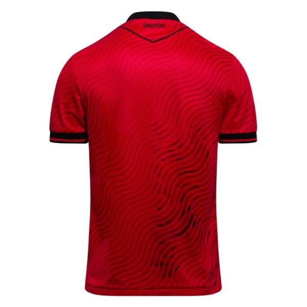 Back view of a red polo shirt with a black wavy line pattern and black-cuffed sleeves.