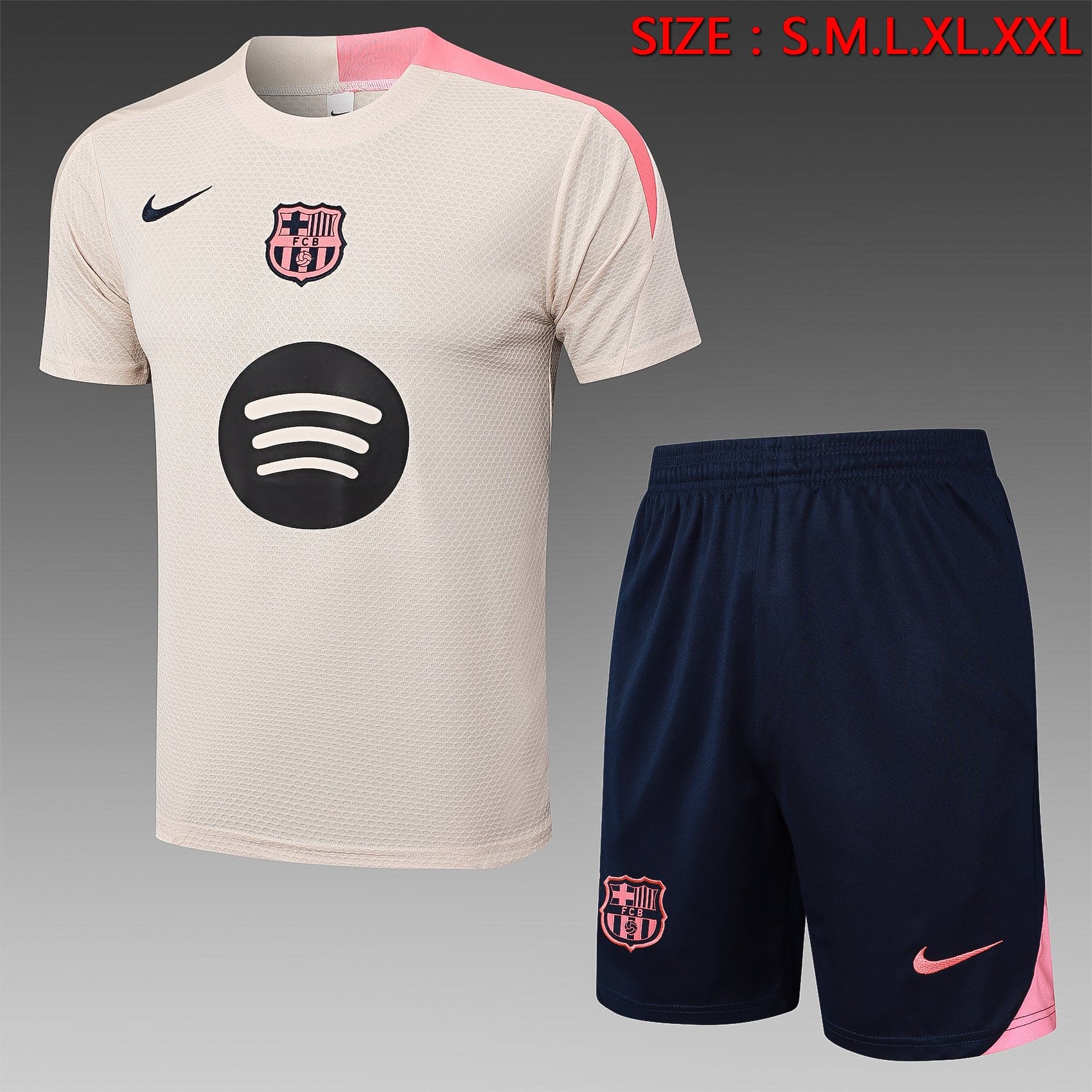 24e12209 | UAE SPORT STORE Beige Barcelona football jersey with pink trim and sponsor logo, paired with navy shorts featuring the Barça crest and pink Nike swoosh.