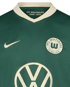 Close-up of a green VfL Wolfsburg football jersey with a white collar, Nike swoosh, club crest, and Volkswagen logo.