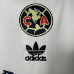 White fabric featuring two logos: circular map badge with red 'CA' and an Adidas trefoil with 'adidas' text beneath