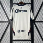 White baseball jersey on a hanger featuring a large Corona logo on the chest and the AT&T logo near the lower front, with dark blue trim and red chevron accents on the sides.
