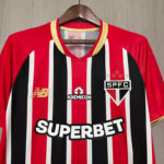 Red and black vertical striped São Paulo FC jersey with 'SUPERBET' sponsor and SPFC crest on the chest background on a hanger.