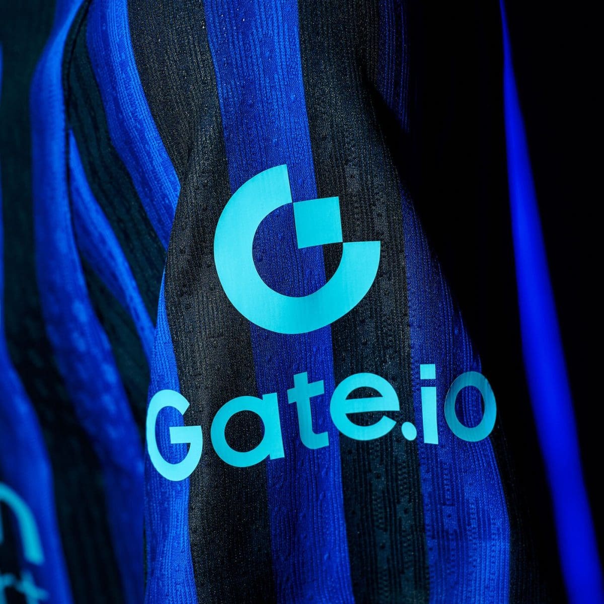 Close-up of a blue striped fabric featuring the turquoise Gate.io logo and text.