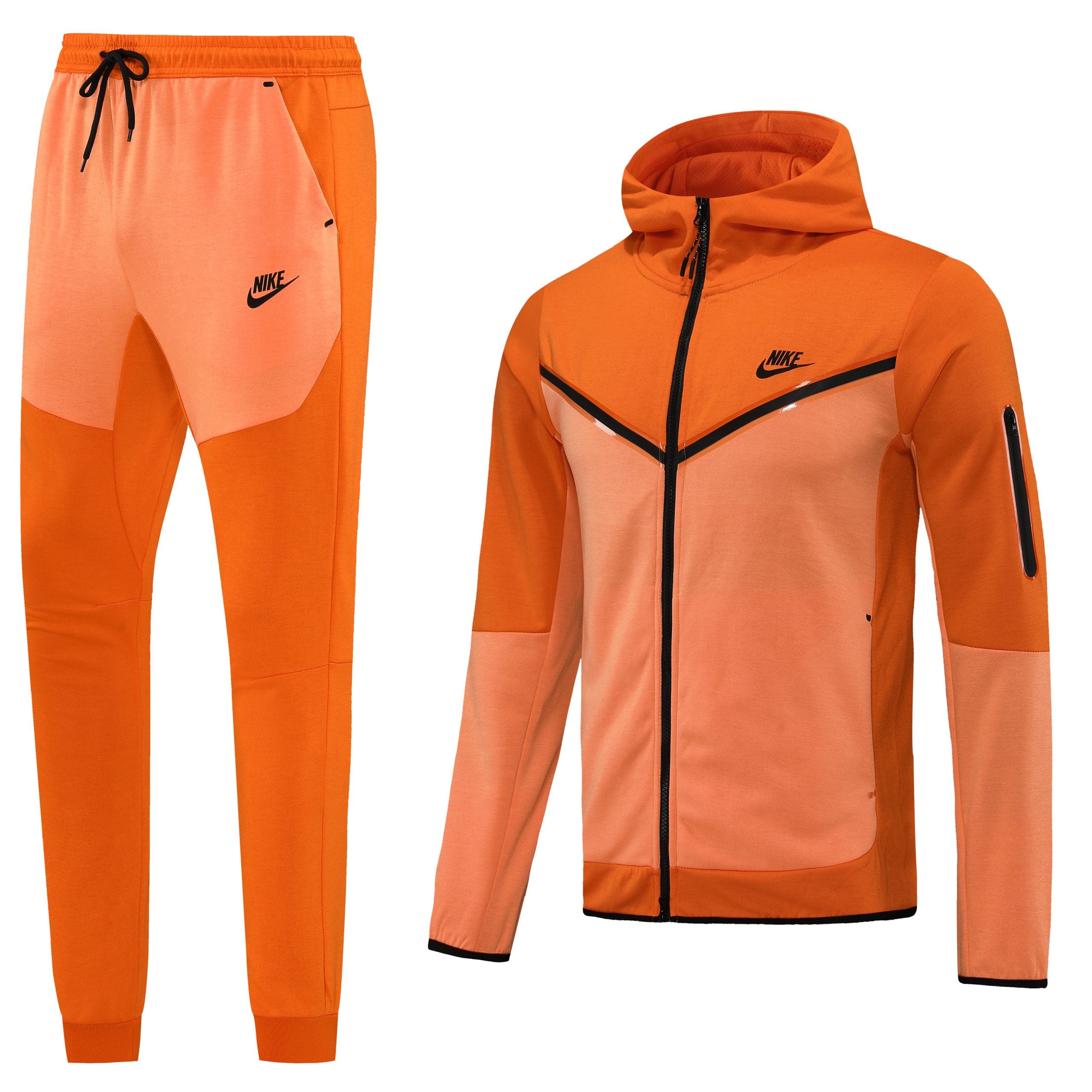 262-scaled_34fa3c5d-af08-4676-ad4c-e254b3549470 Orange Nike tracksuit set with zip-up jacket and jogger pants, bright athletic wear with black zipper and swoosh logo.