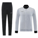 Nike black jogger pants with white swoosh paired with a light gray zip-up jacket featuring a black collar and cuffs.