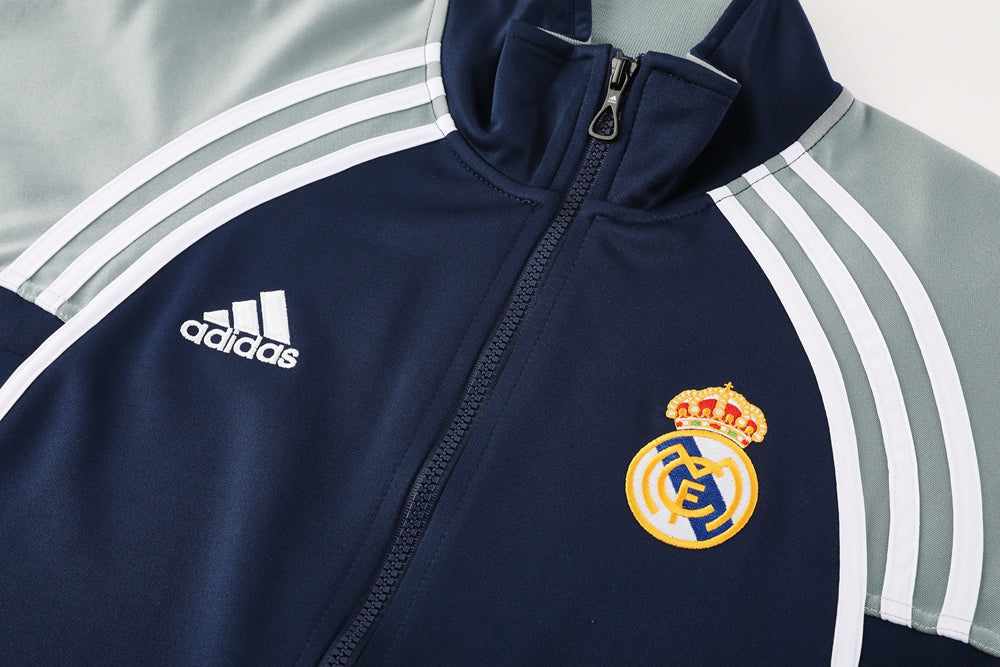 26ecadb6 | UAE SPORT STORE Navy Real Madrid track jacket with Adidas logo, crest on the chest and white sleeve stripes.