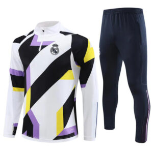 Geometric-pattern Real Madrid training jersey in white with black, purple, and yellow accents, paired with navy track pants.