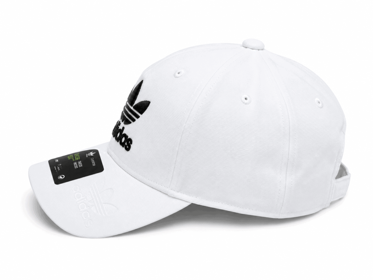 White Adidas baseball cap with a black trefoil logo on the front and a curved brim.