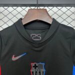Black sports jacket on a wooden hanger with red and blue shield patches, against a chain-link fence.
