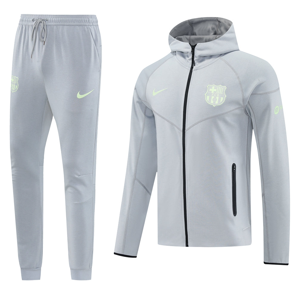 27e2d9c6 Light gray athletic tracksuit: hooded zip jacket and matching joggers with neon-green Nike swoosh and FC Barcelona crest.