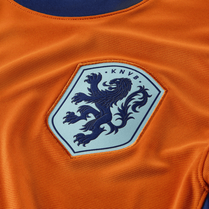 27e5d614_554f_4f0b_91be_af2f4dd6915e | UAE SPORT STORE Orange football jersey with the KNVB crest featuring a blue lion emblem.