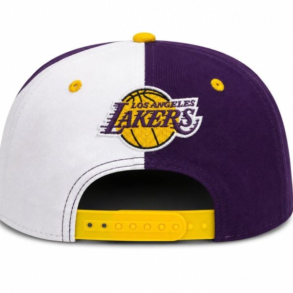 Back view of a Los Angeles Lakers cap split white left and purple right, with a yellow logo and a yellow adjustable strap visible at the back