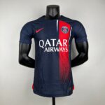 Mannequin wearing a navy PSG football jersey with a red vertical stripe and QATAR AIRWAYS sponsor, crest visible on chest.