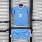 Blue soccer jersey on a hanger with pink-white striped collar, white Adidas logo, and circular crest on the chest, hanging in a metal rack.