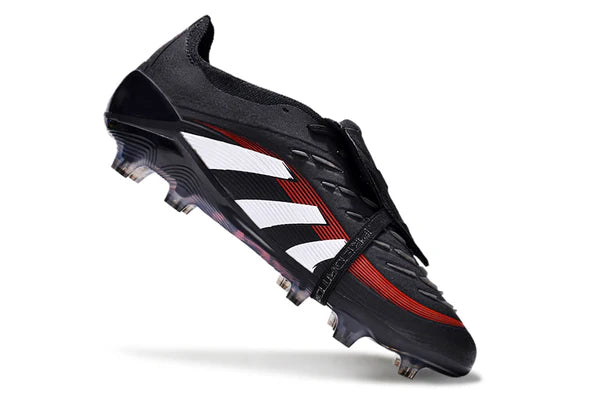 Black soccer cleat with white stripes and red accents, shown angled mid-air with studded sole in view.