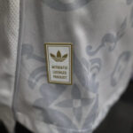 Close-up of gray fabric with a small rectangular badge reading 'AUTHENTIC LICENSED PRODUCT' and a trefoil logo above the text.