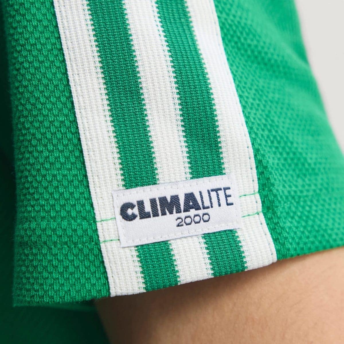 Close-up of a green fabric with white striped strap and a tag reading 'CLIMATE' on a garment.