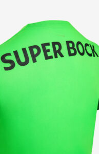 2CCO0BVjLTzyHP4 | UAE SPORT STORE Close-up of a bright green sports jersey with bold black text reading 'SUPER BOCK' along the shoulder edge.
