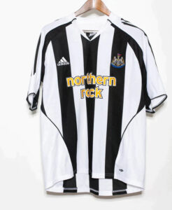 Newcastle United football jersey with black and white vertical stripes, sponsor 'Northern Rock' and Adidas logo on the chest.
