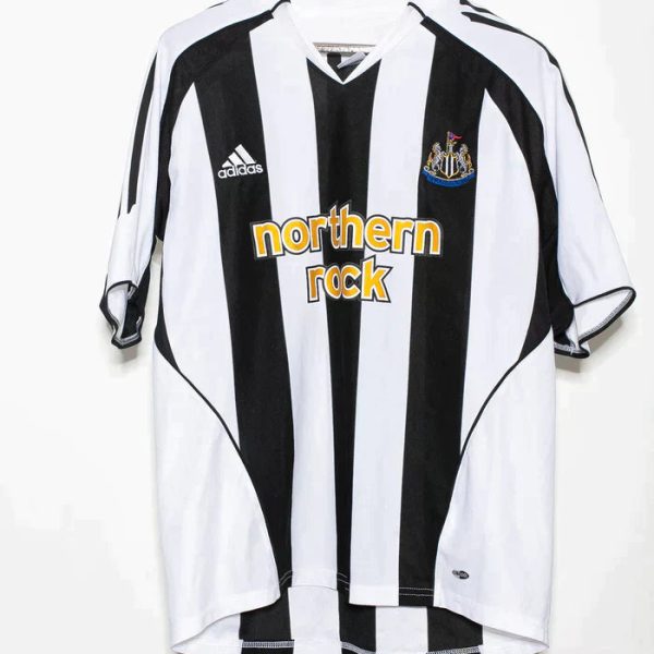 Newcastle United football jersey with black and white vertical stripes, sponsor 'Northern Rock' and Adidas logo on the chest.