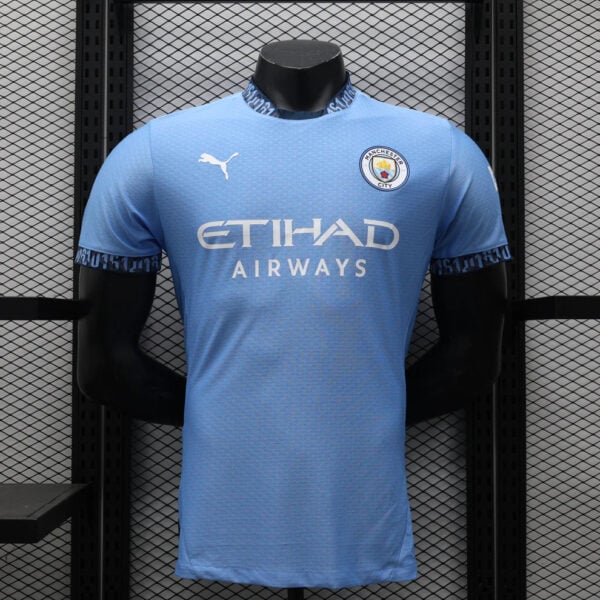 Manchester City home football jersey on a display mannequin, light blue with Etihad Airways sponsor and Puma logo.