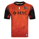Orange soccer jersey with black sleeves and a tree-and-bat graphic, featuring MSC sponsor text and team crest, plus a small Italian flag badge near the collar.