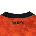Back of an orange soccer jersey with a black collar and the text 'SSC NAPOLI' in black.