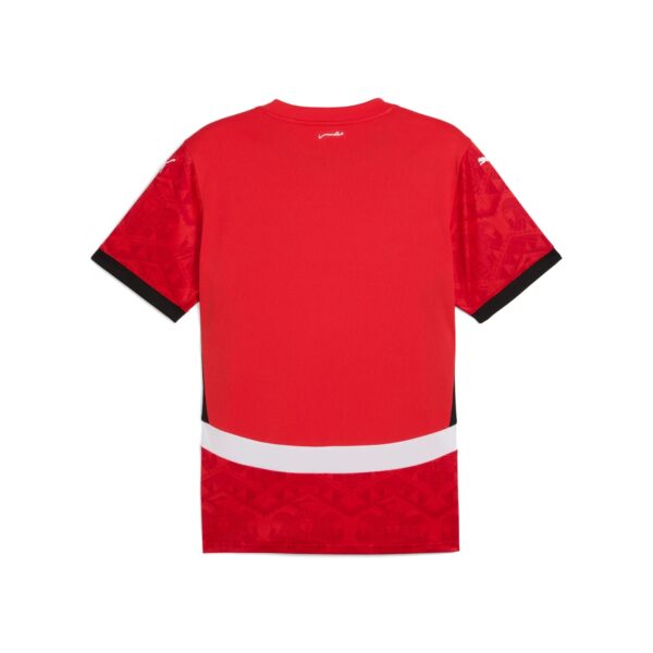 Back view of a red athletic jersey with black sleeve cuffs and a white horizontal band near the lower back.