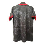 Back view of a dark gray sports jersey with white sketch-style artwork and red sleeve cuffs.