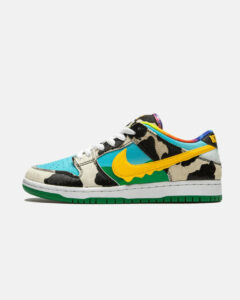 2_d2bc4ec7-1772-4e82-a6b0-88694405d961 | UAE SPORT STORE Colorful camo-pattern sneaker with teal toe and yellow Nike swoosh on a green outsole, side view.