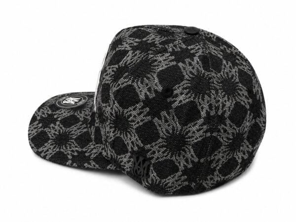 Black monogram cap featuring skull and floral patterns, stylish and trendy headwear.