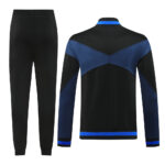 2a97ad5f | UAE SPORT STORE Back view of a black athletic tracksuit with blue color-blocked jacket and matching blue trim on cuffs and hem, paired with plain black jogger pants.
