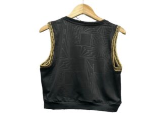 Black satin sleeveless vest with gold embroidered trim along the armholes, hanging on a wooden hanger back view.