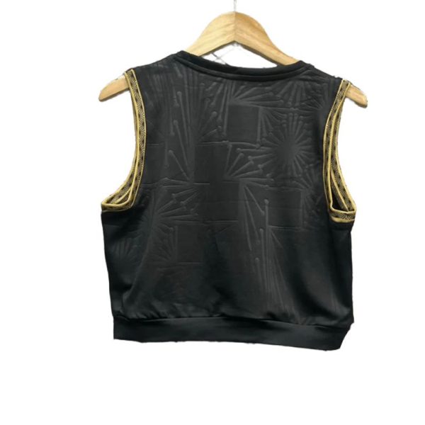 Black satin sleeveless vest with gold embroidered trim along the armholes, hanging on a wooden hanger back view.