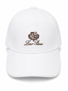 2b2a46e5-0dd3-41d9-8696-e59f626117e8 | UAE SPORT STORE White baseball cap with brown embroidered crest and 'Loro Piana' script on front.