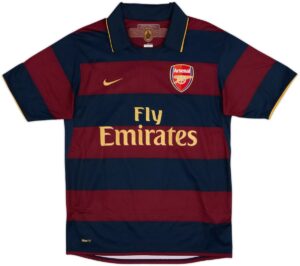 Arsenal football jersey with navy and maroon horizontal stripes, Nike logo, crest on the chest, and Fly Emirates sponsor text in gold.